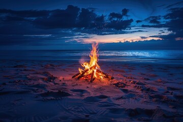 a campfire on a sandy beach at night