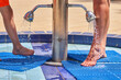 © Kalim - Picture of washing legs before pool entrance