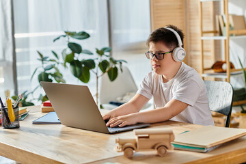 Child with Down syndrome with headphones, laptop, home setting.