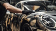 © Pavel - Car wrapping specialist at work applying camouflage car wrap on sportscar. Camo car film installation service