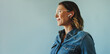 © Jacob Lund - Focused and engaged: Businesswoman in denim jacket working with earphones in studio