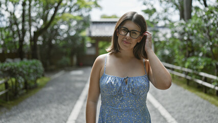 Canvas Print - Beautiful young hispanic woman wearing glasses standing smiling at kyoto temple