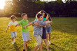 © Studio Romantic - Happy small friends boys and girls playing tag running on green lawn and enjoying good weather and having great weekend with classmates from school located in sunny park. Children, teenagers