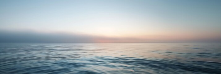 Wall Mural - Calm ocean waters under a soft pastel sunrise offering a peaceful and serene landscape.