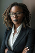 © sommersby - A professional woman in a formal suit and glasses posing confidently for a camera
