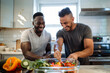 © wolfhound911 - Two guys, one African American and the other Hispanic, are having fun while making salad together in the kitchen. The scene portrays a concept of gay couples and everyday life at home, as they bond