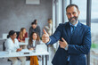 © Dragana Gordic - Confident businessman posing in the office, he is smiling at camera. Portrait of happy mature businessman looking at camera. Multiethnic satisfied man with beard feeling confident at office.