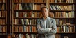 © gunzexx png and bg - Mature man with confident posture standing in front of a large bookshelf in a stylish library