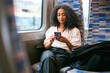 © Monkey Business - Businesswoman Commuting To Work On Train Sitting Checking Messages Or Social Media On Mobile Phone