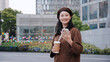 © zhouyilu - Urban Professional Enjoying a Coffee Break with Smartphone