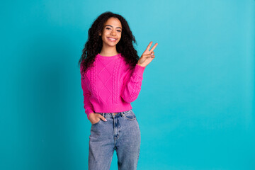 Wall Mural - Photo of lovely young girl show v-sign empty space wear pink pullover isolated on teal color background