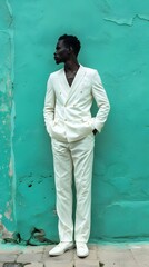 Wall Mural - Man in a white suit standing against a green wall