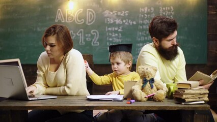Fototapete - The family school. Young mother father and little preschooler boy sit at table drawing together, playing, painting pictures in notebook, early development.