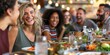 © gunzexx png and bg - A group of happy friends sharing laughter and conversation over a meal in a casual dining restaurant with a lively ambiance