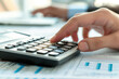 © siripimon2525 - accountant's hands pressing buttons on a calculator in an office