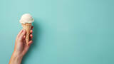 Fototapeta  - Ice cream in hand on blue background with copy space.