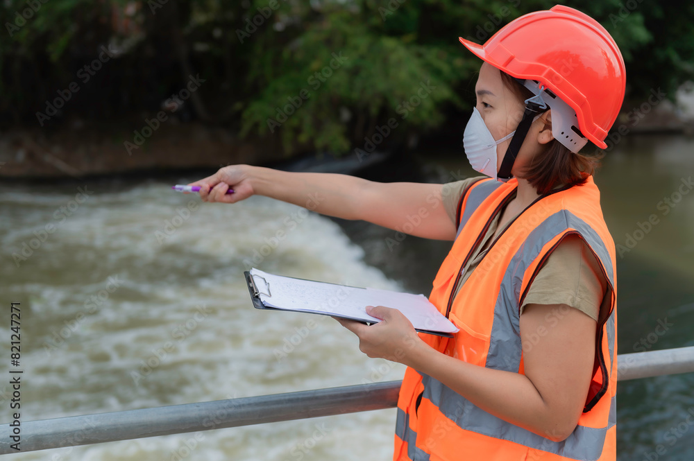Asian Female engineering working . at sewage treatment plant,Marine biologist analysing water test results,World environment day concept