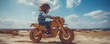 © gearstd - Child riding a cardboard motorcycle in desert