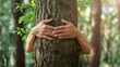 © Ilmi - Hug a tree, Green natural background. Concept of people love nature and protect from deforestation or pollution or climate change