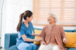 © chokniti - nursing home assistance in health insurance business concept, asian woman doctor or nurse caregiver support health care to elderly senior patient person, caretaker in medicals care recovery service