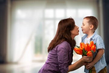 Sticker - Mother's day concept. Child congratulating mother giving bouquet of flowers.