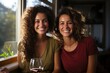 © Gabriel - Two happy and carefree women, looking at the window and holding a glass of wine. W, generative IA