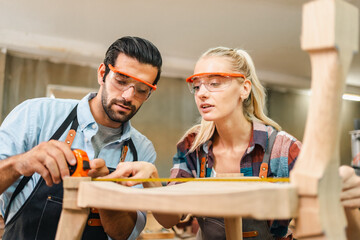 Wall Mural - professional artisan carpenters woodworking team work together creatively, creative carpenter woman working workshop for wooden craft with wood tool at industry carpenter's shop, business of wood