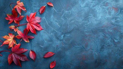 Autumn background with colored red leaves on blue slate background.