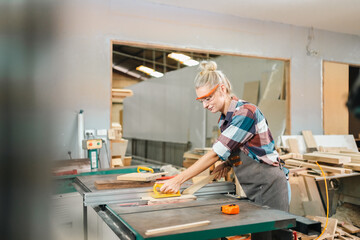 Wall Mural - professional artisan carpenters woodworking team work together creatively, creative carpenter woman working workshop for wooden craft with wood tool at industry carpenter's shop, business of wood