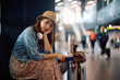 © Drazen - Young traveler feeling distraught about her delayed flight at airport. Copy space.