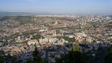 Fototapeta  - Wide angle view of beautiful city if Tbilisi and Kura river from Mount Mtatsminda with Holy Trinity Cathedral in the center and Old Town on the right side