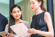 © chokniti - Asian businessman present start up project to expert investor, Teamwork group of multicultural business team solving problems, discussing business idea with skyscraper at modern business lounge