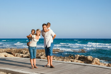 Wall Mural - A happy family playing by the sea in nature travel