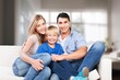 © BillionPhotos.com - Happy family with children watching TV together at home.