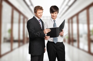 Two successful business people posing in office interior