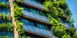 © dinastya - Modern sustainable building with solar panels, vertical garden with green plants.