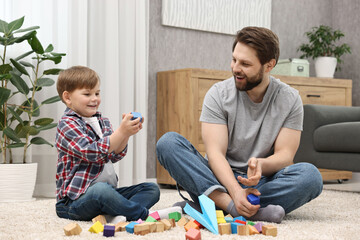 Canvas Print - Happy dad and son playing with cubes at home