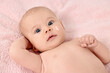 © New Africa - Cute little baby with cream on face on pink blanket, above view