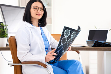 Sticker - Female doctor with MRI scan sitting in clinic