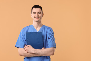 Sticker - Portrait of smiling medical assistant with clipboard on beige background. Space for text