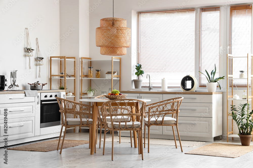 Dining table, chairs and lamp in stylish kitchen