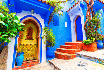 Chefchaouen, Morocco: Blue narow stairs with colourful walls and flowerpots into old walled city, or medina, North Africa