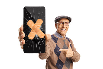 Poster - Senior man holding a mobile phone with cracked screen fixed with a tape and pointing