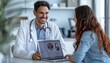 © ЮРИЙ ПОЗДНИКОВ - Doctor sharing organ data with patient on laptop, both smiling