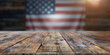 © Gabriela - Empty wooden table to place advertising or product, you can see out of focus American flag in the background, 4th of July celebration