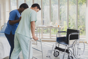 Portrait patient caucasian man sit wheelchair with woman nurse black people carer physical therapist two person talk helping support give advice feel relax smile happy in hospital clinic room service.