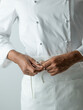 © The Picture Pantry - Chef tying apron in chefs whites