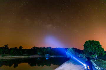 star natural background At night, the Milky Way can be clearly seen with the naked eye, with the blur of light hitting the water surface and the cool, humid air.