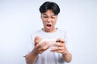 © Queenmoonlite Studio - Potrait Of Annoyed Young Asian Guy Playing Game On Smartphone And Screaming Isolated On White Background