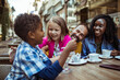 © Vorda Berge - Happy multiethnic family enjoying time at a cafe together